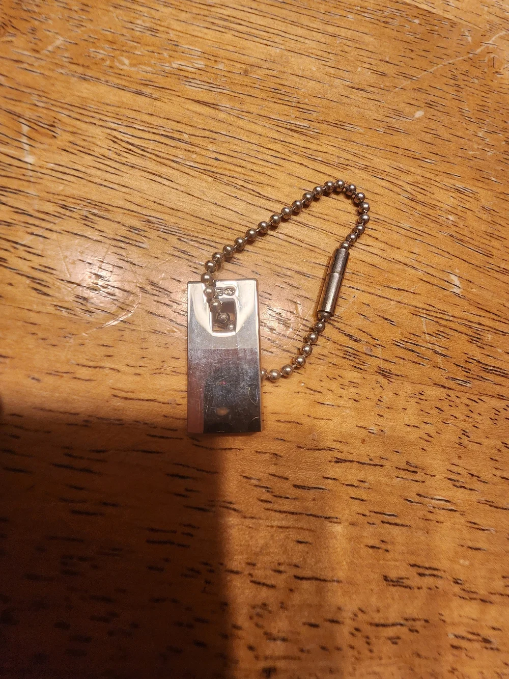 Gucci Sterling Silver Logo Tag likely used on a bracelet or keychain